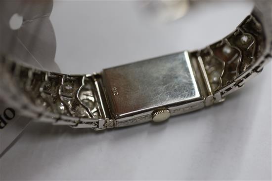 A ladys mid 20th century 18ct white gold, sapphire and diamond set manual wind cocktail watch,